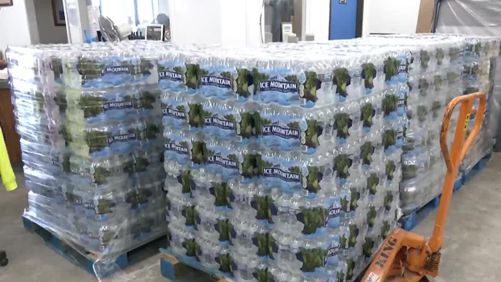 Wrapped cases of Ice Mountain 16.9 oz bottles in branded packaging, stacked and ready for bulk delivery to commercial or event locations.